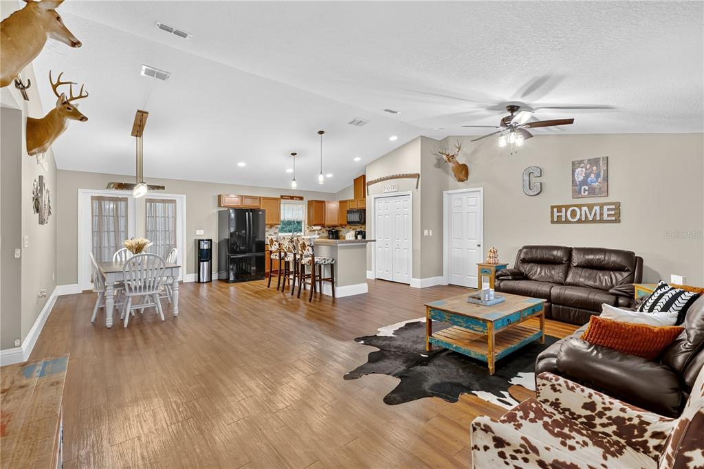 396 North Post Office Road Kenansville, FL 34739 - Photo 3 of 34 a living room with furniture and wooden floor