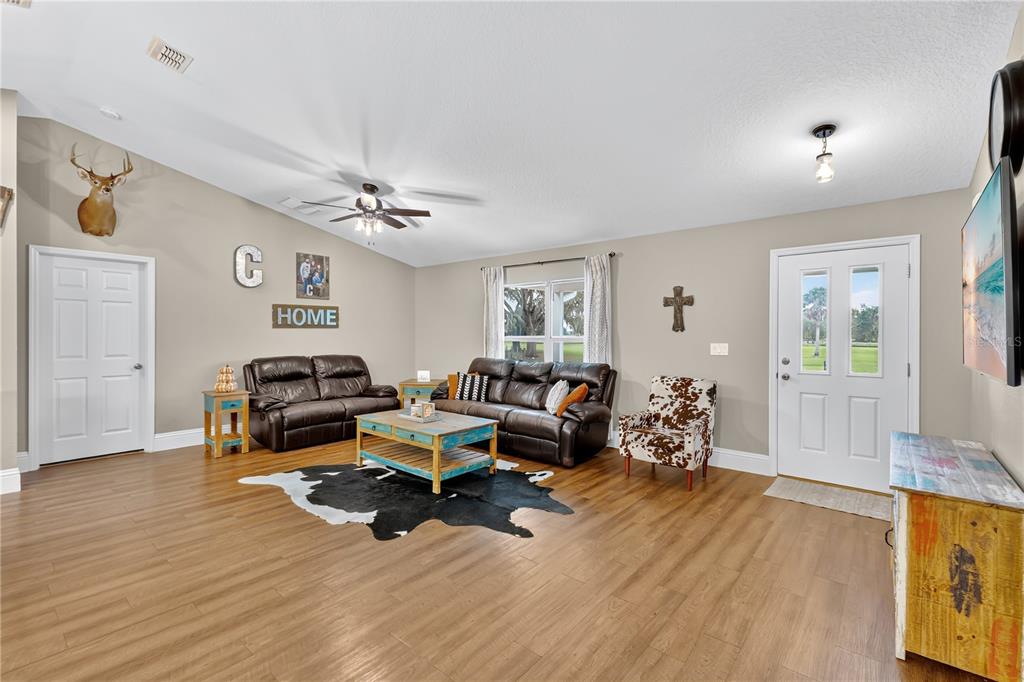 396 North Post Office Road Kenansville, FL 34739 - Photo 4 of 34 a living room with furniture and wooden floor