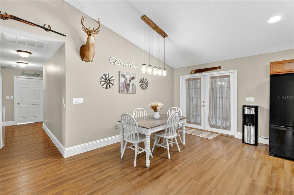 396 North Post Office Road Kenansville, FL 34739 - Photo 5 of 34 a view of a dining room with furniture and wooden floor