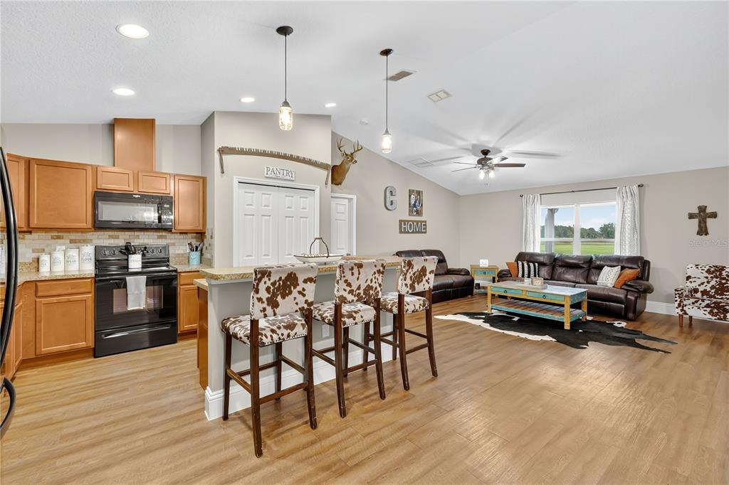 396 North Post Office Road Kenansville, FL 34739 - Photo 6 of 34 a living room with furniture kitchen and a wooden floor