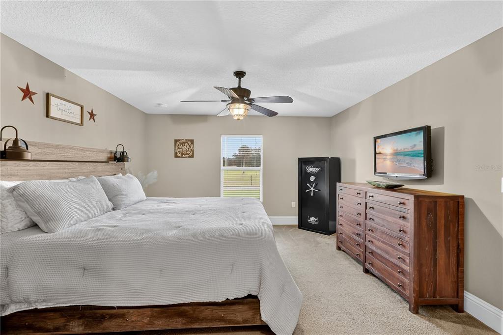 396 North Post Office Road Kenansville, FL 34739 - Photo 10 of 34 a bedroom with a bed and a television