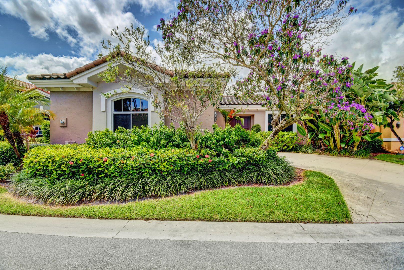 20710 Northwest 29th Avenue Boca Raton, FL 33434 - Photo 1 of 35 a front view of a house with a garden