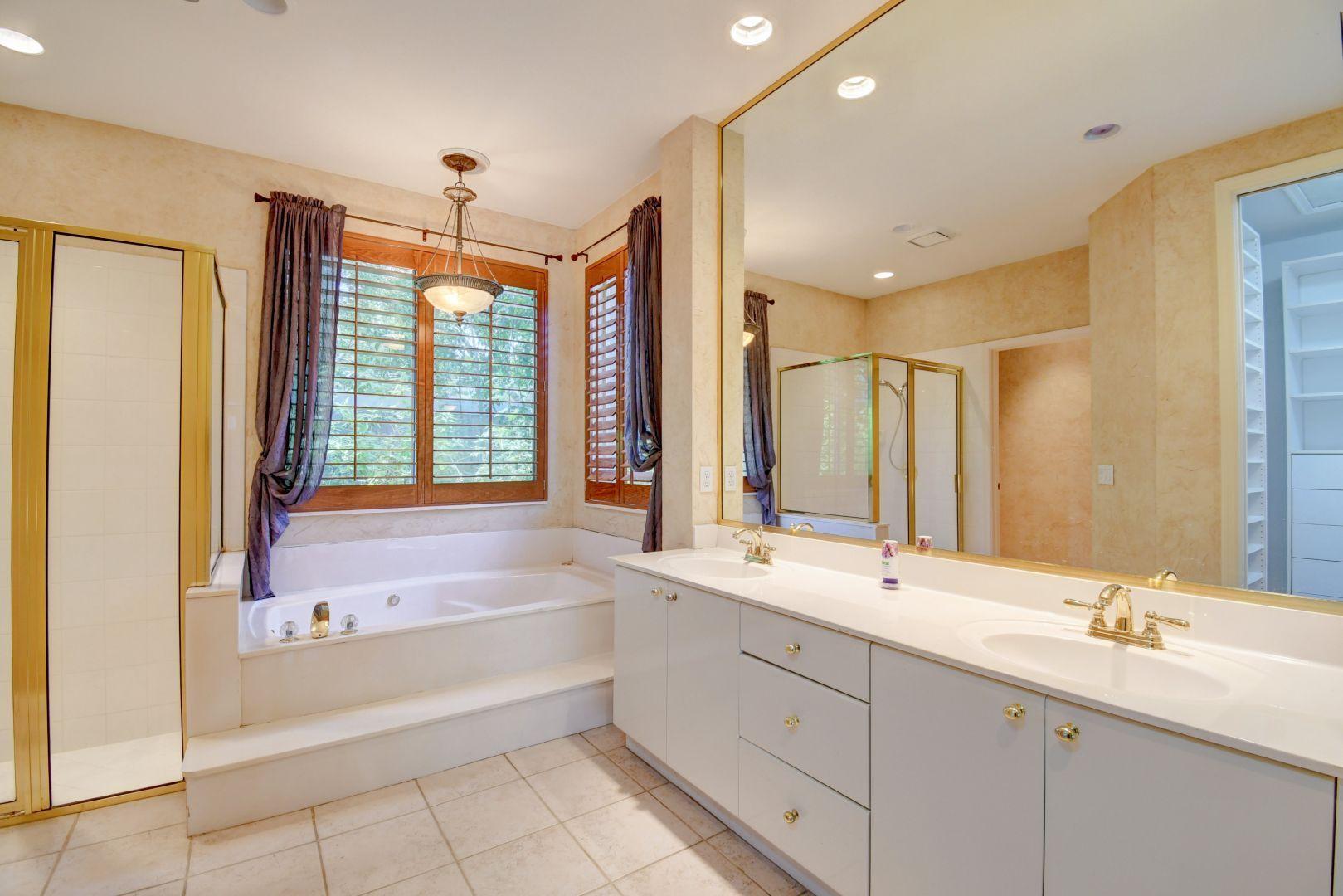 20710 Northwest 29th Avenue Boca Raton, FL 33434 - Photo 12 of 35 a bathroom with a double vanity sink large mirror and a bathtub