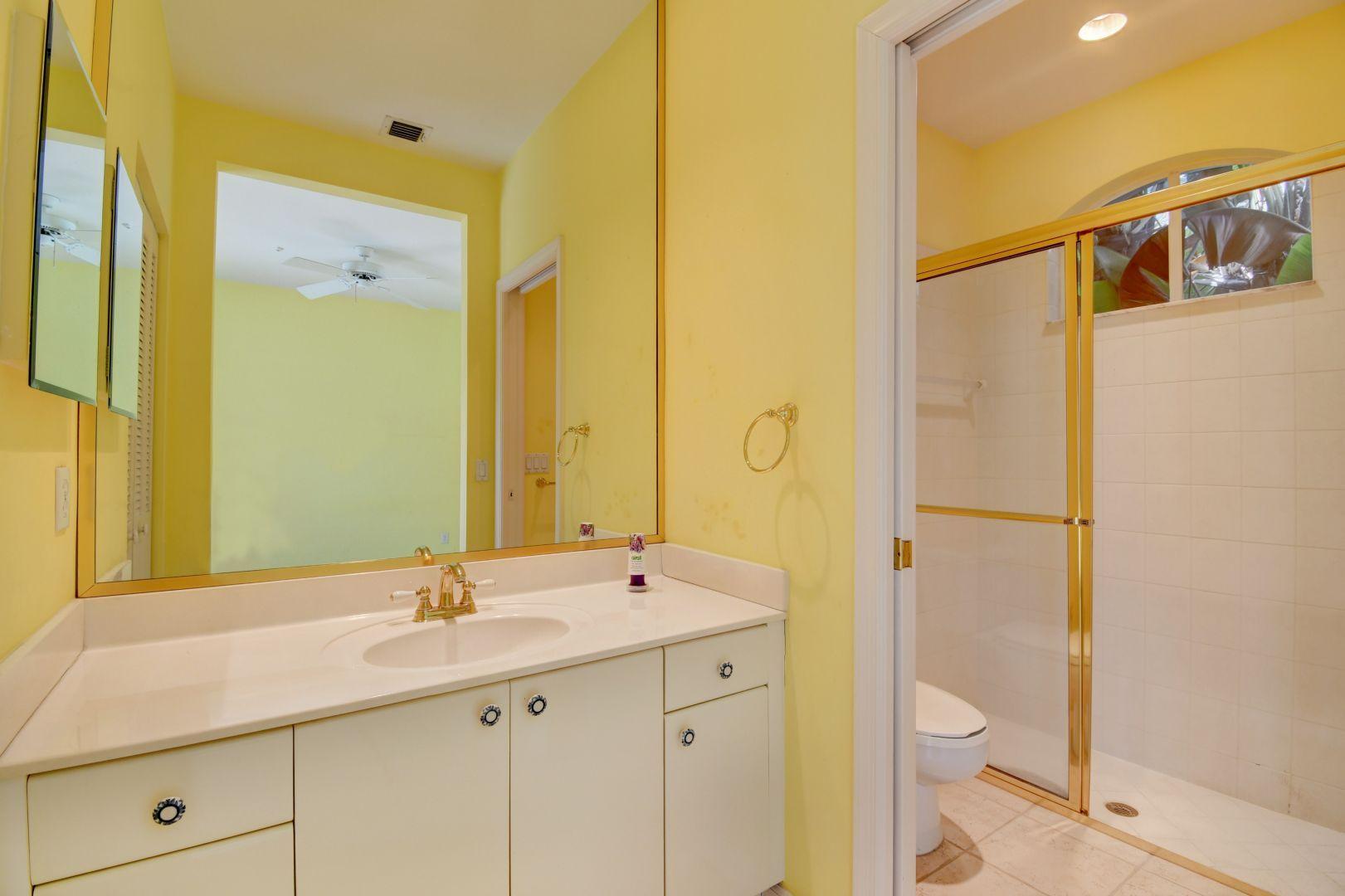 20710 Northwest 29th Avenue Boca Raton, FL 33434 - Photo 16 of 35 a bathroom with a sink a toilet and shower