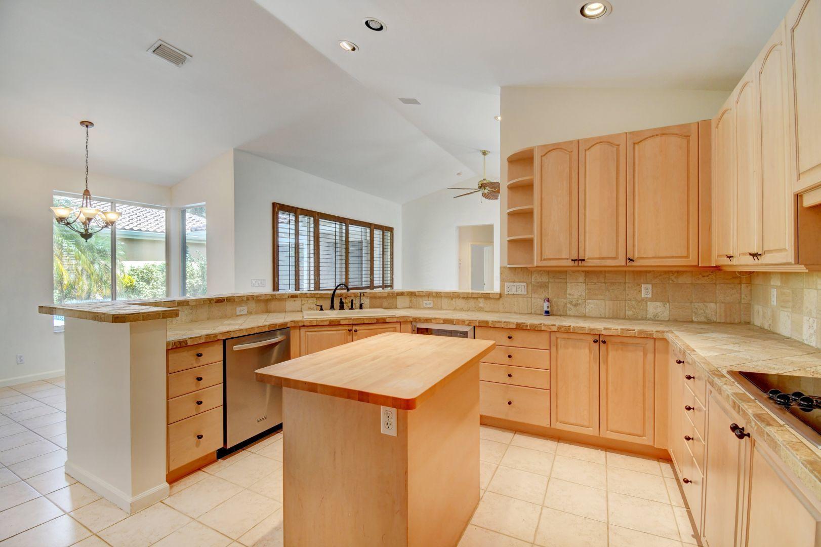 20710 Northwest 29th Avenue Boca Raton, FL 33434 - Photo 25 of 35 a kitchen with stainless steel appliances granite countertop white cabinets and window