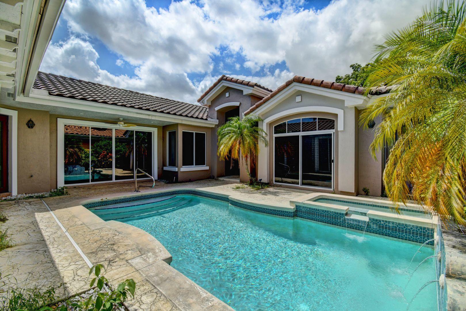 20710 Northwest 29th Avenue Boca Raton, FL 33434 - Photo 33 of 35 front view of a house with a big yard