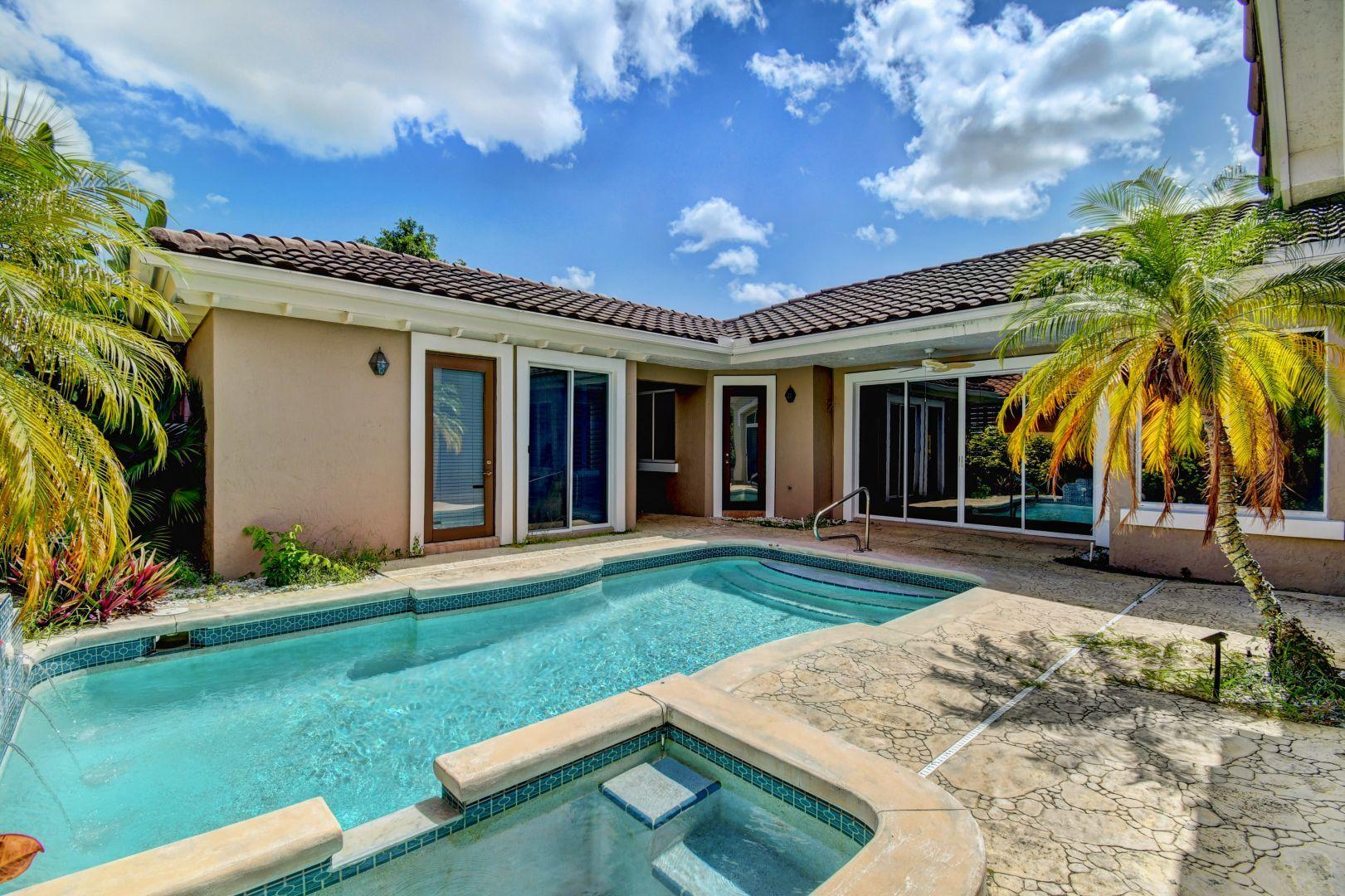 20710 Northwest 29th Avenue Boca Raton, FL 33434 - Photo 34 of 35 front view of a house with a yard