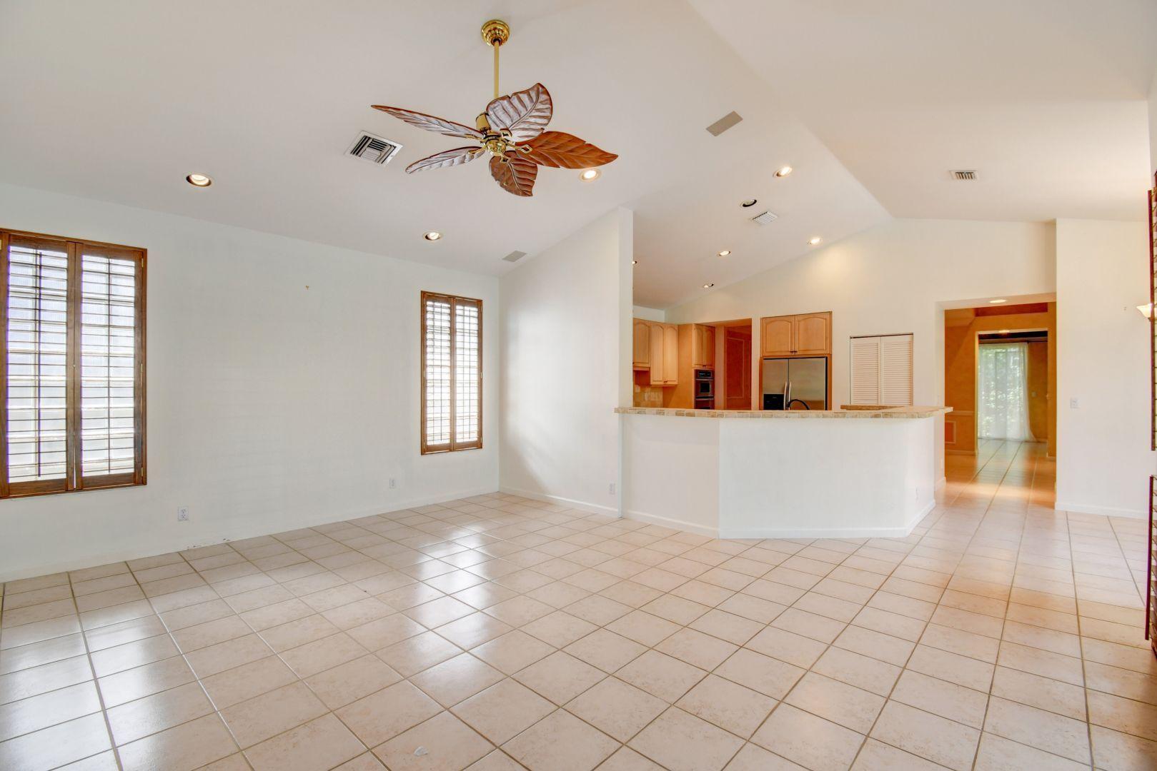 20710 Northwest 29th Avenue Boca Raton, FL 33434 - Photo 5 of 35 an empty room with windows and ceiling fan