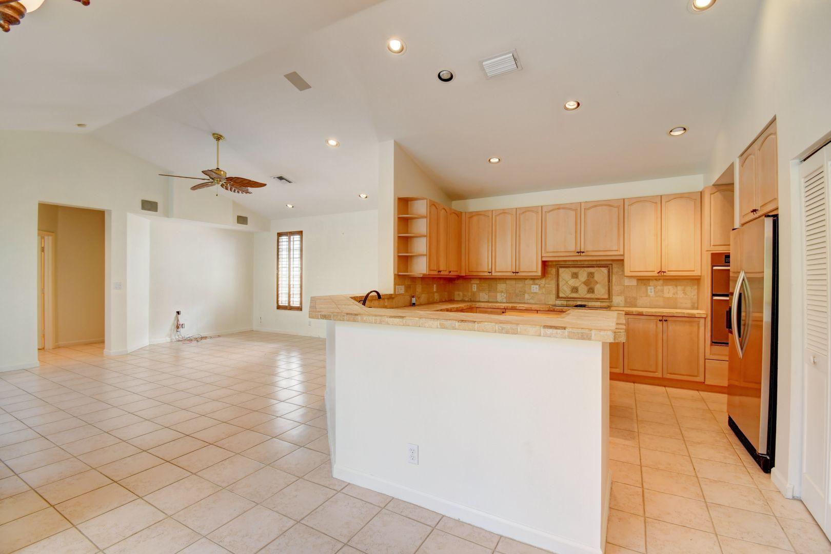 20710 Northwest 29th Avenue Boca Raton, FL 33434 - Photo 8 of 35 a kitchen with stainless steel appliances granite countertop a refrigerator and a stove top oven