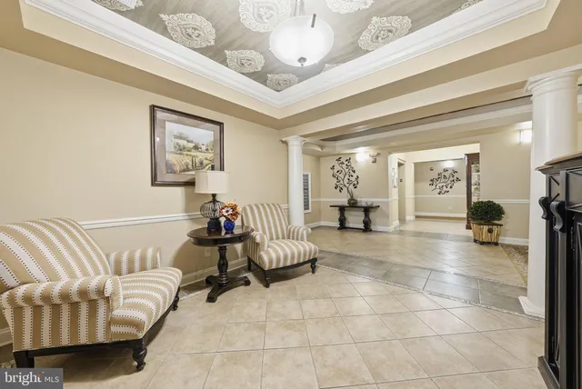 a living room with furniture and a chandelier