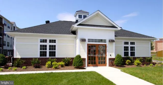 a front view of a house with a yard and outdoor seating