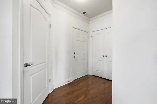 a view of a room with wooden floor