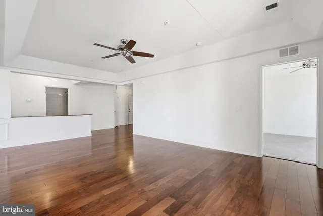 a view of empty room with wooden floor