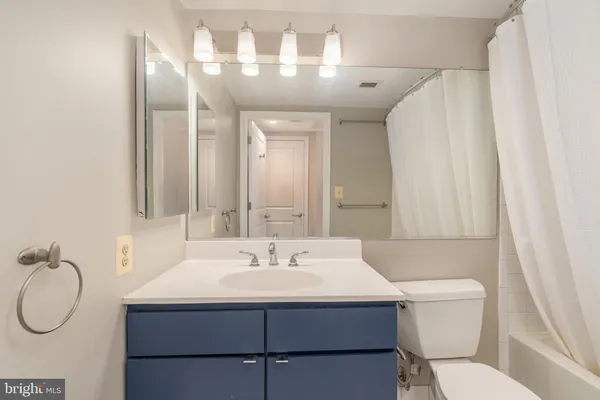 a bathroom with a sink mirror vanity and toilet