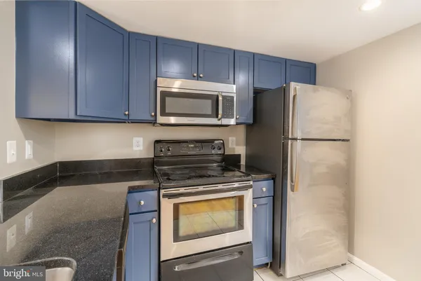 a kitchen with cabinets and stainless steel appliances