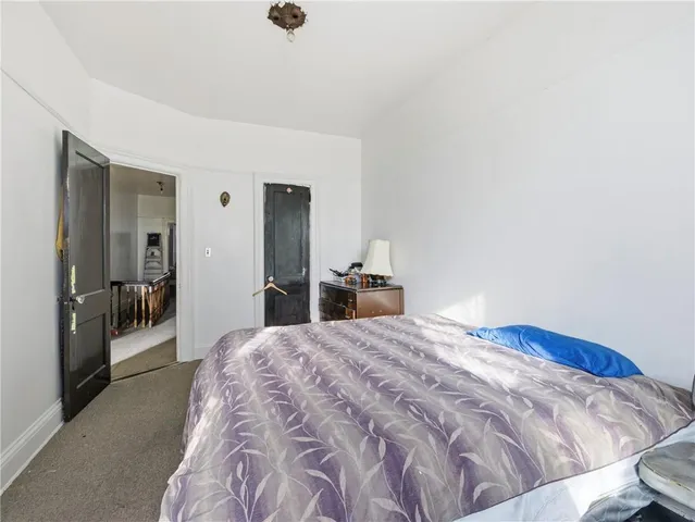 a bedroom with a bed and a view of bathroom