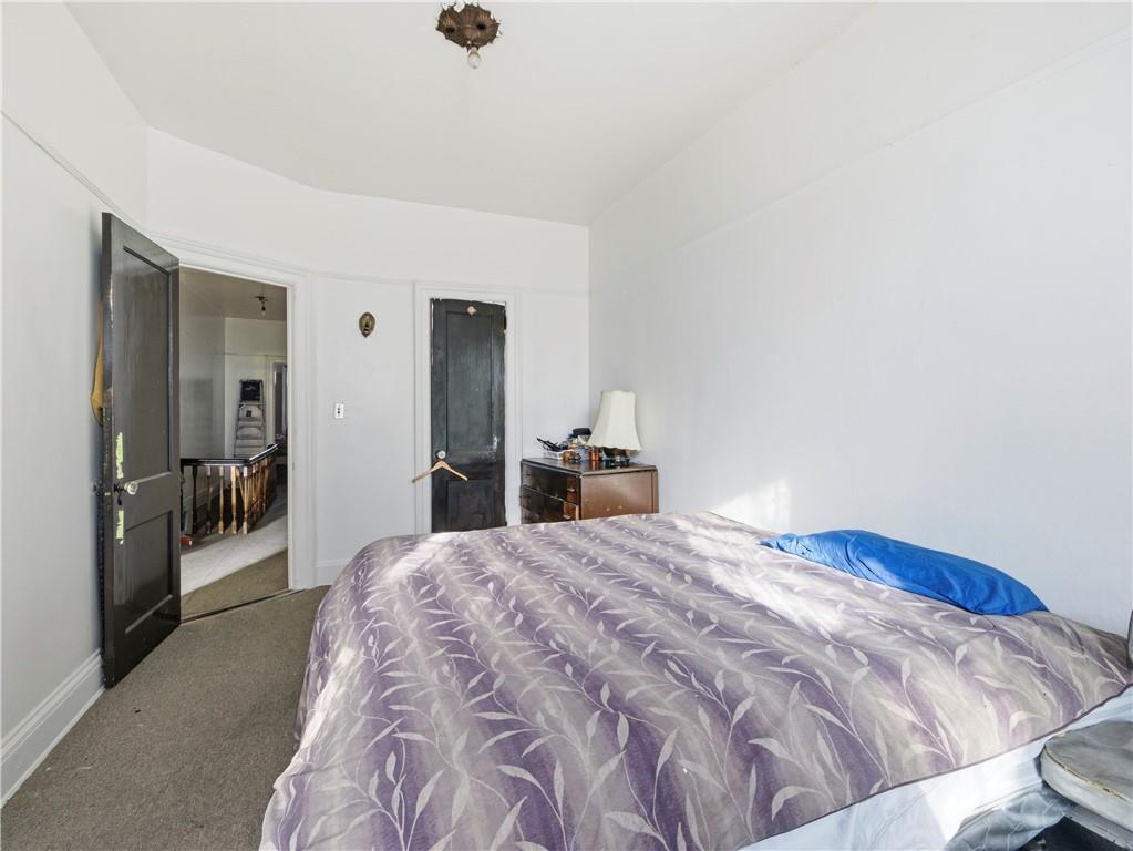 372 Parkside Avenue Brooklyn, NY 11226 - Photo 15 of 34 a bedroom with a bed and a view of bathroom