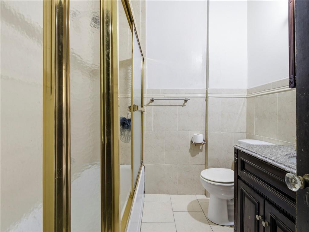 372 Parkside Avenue Brooklyn, NY 11226 - Photo 16 of 34 a bathroom with a toilet and a shower