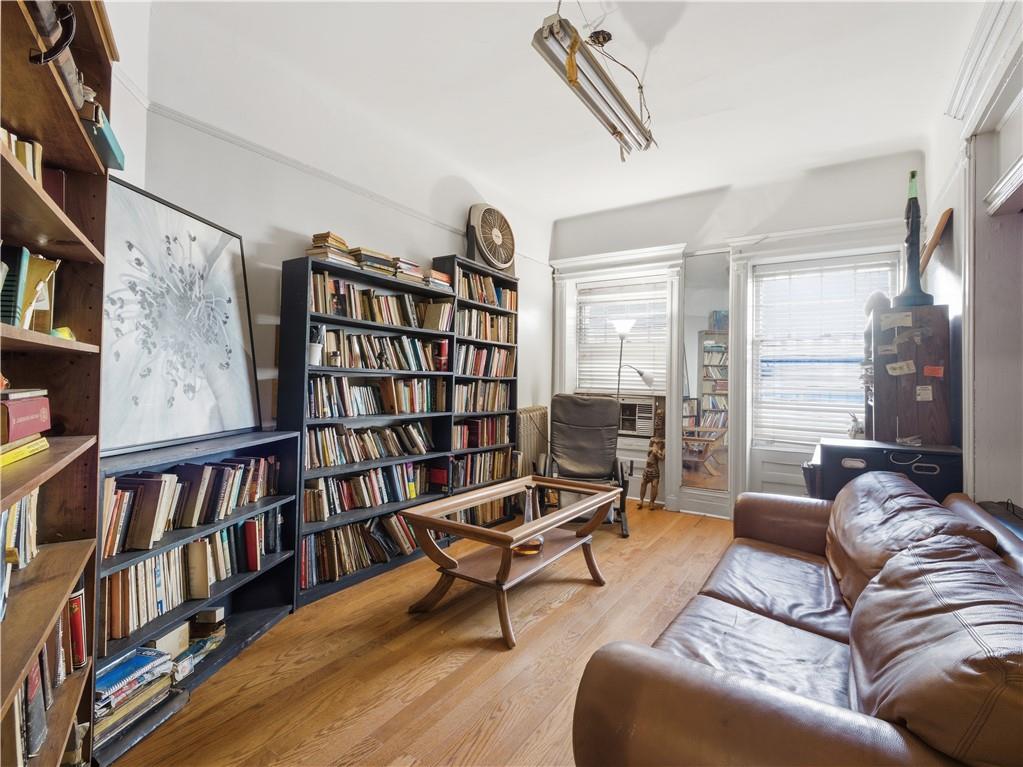 372 Parkside Avenue Brooklyn, NY 11226 - Photo 2 of 34 a living room with furniture and a book shelf