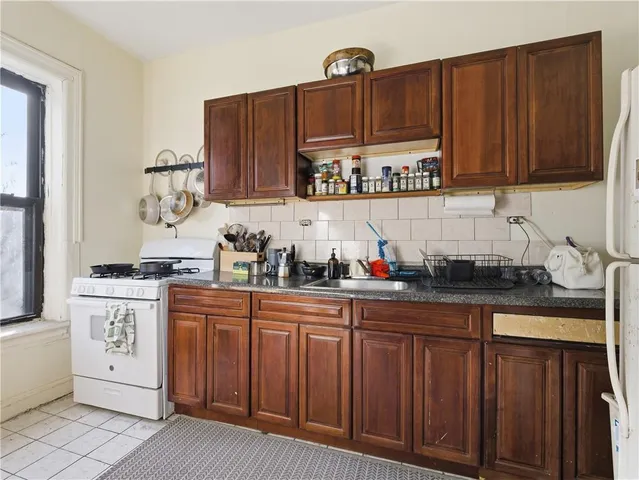 a kitchen with stainless steel appliances granite countertop a sink dishwasher stove and cabinets