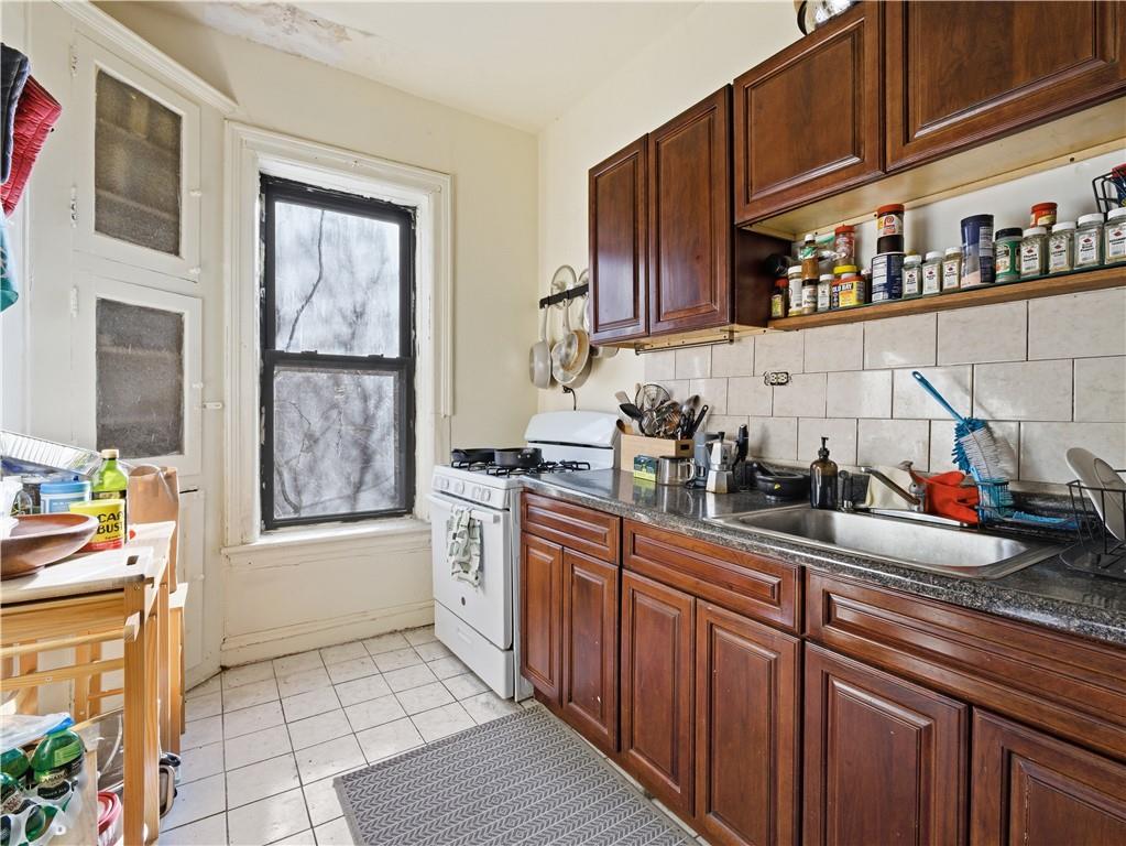 372 Parkside Avenue Brooklyn, NY 11226 - Photo 29 of 34 a kitchen with stainless steel appliances granite countertop a sink stove and cabinets