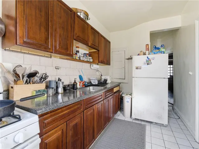 a kitchen with stainless steel appliances granite countertop a refrigerator a stove a sink and dishwasher