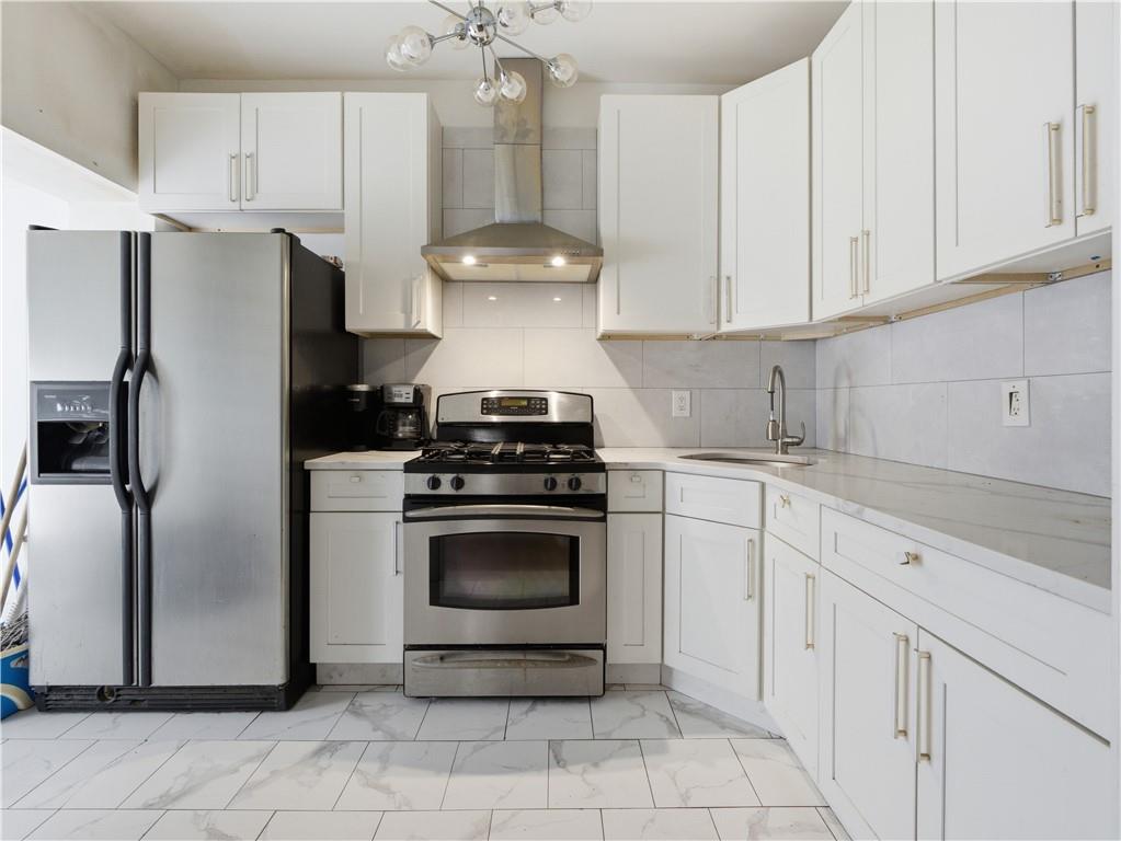 372 Parkside Avenue Brooklyn, NY 11226 - Photo 5 of 34 a kitchen with cabinets stainless steel appliances and a counter space