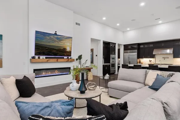 a bedroom with a bed a couch and a ceiling fan