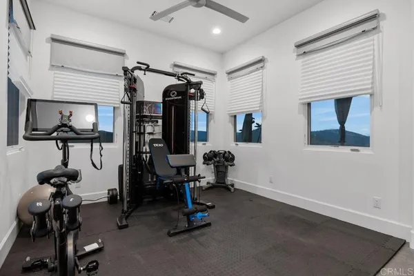 a living room with furniture a flat screen tv and kitchen view