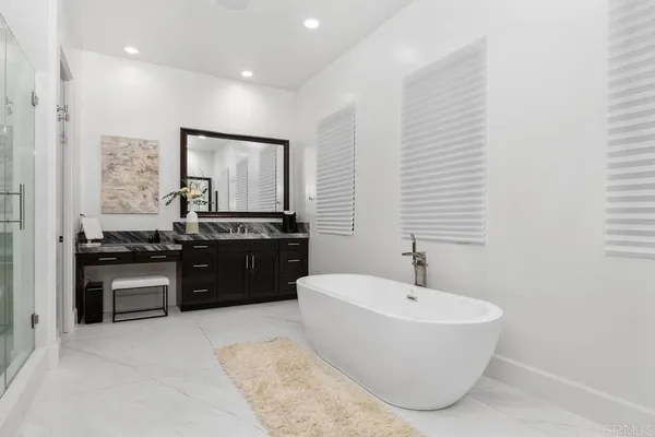 a bathroom with a double vanity sink mirror and toilet