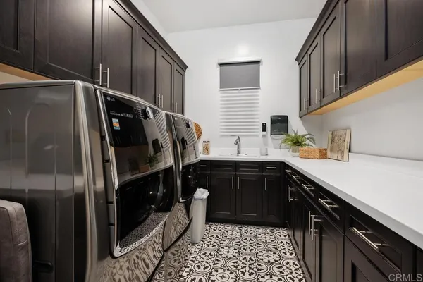 a patio with yard glass top table and sofas