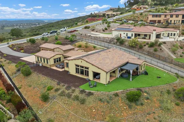 a kitchen with stainless steel appliances granite countertop a sink a stove a refrigerator a dining table and chairs