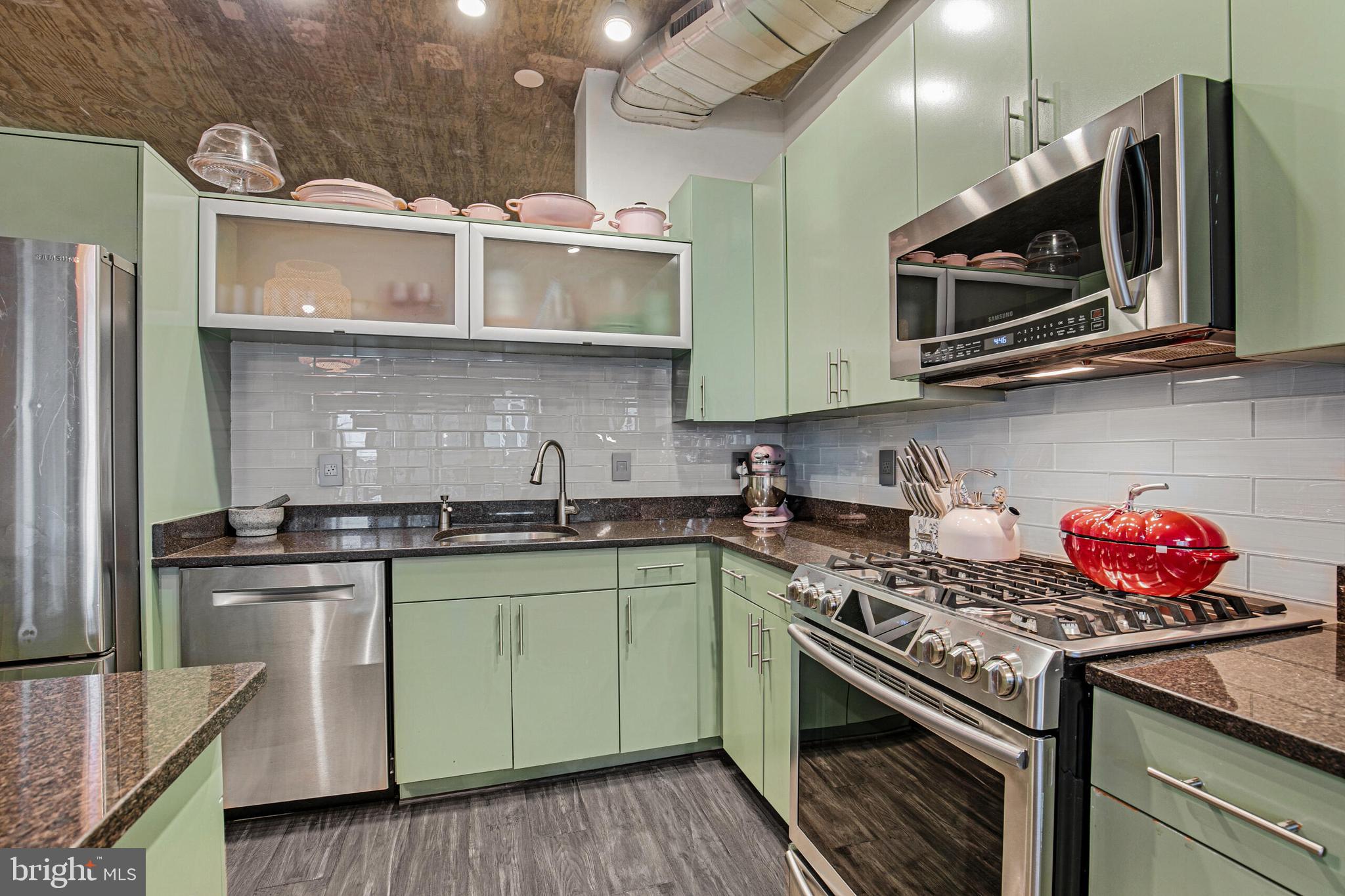 929 Florida Avenue Northwest, Unit 2001 Washington, DC 20001 - Photo 11 of 34 a kitchen with stainless steel appliances granite countertop a sink and a stove