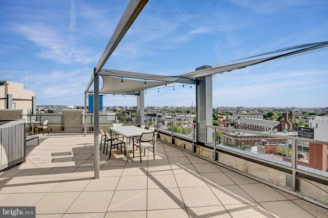 a view of a chairs and table in a balcony