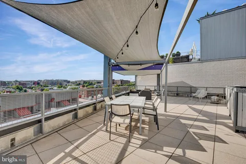 a view of a terrace with furniture and a view of the ocean