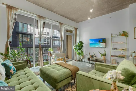 a bedroom with furniture and a large window