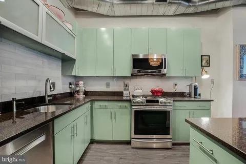 a kitchen with a sink cabinets and stainless steel appliances