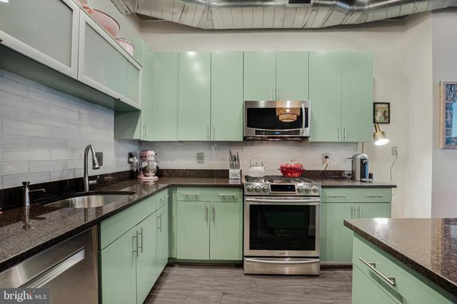 a kitchen with a sink cabinets and stainless steel appliances