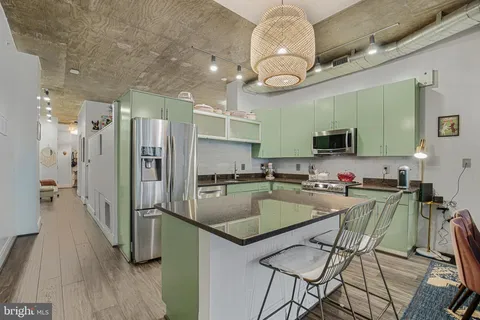 a kitchen with a table chairs refrigerator and microwave