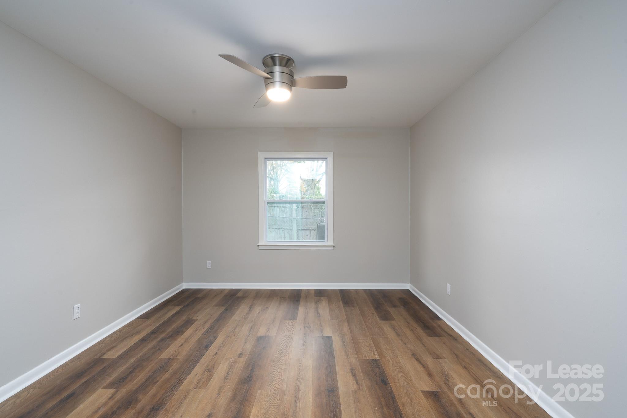 745 Arbor Street Northeast, Unit 5 Concord, NC 28025 - Photo 11 of 20 wooden floor in an empty room with a window