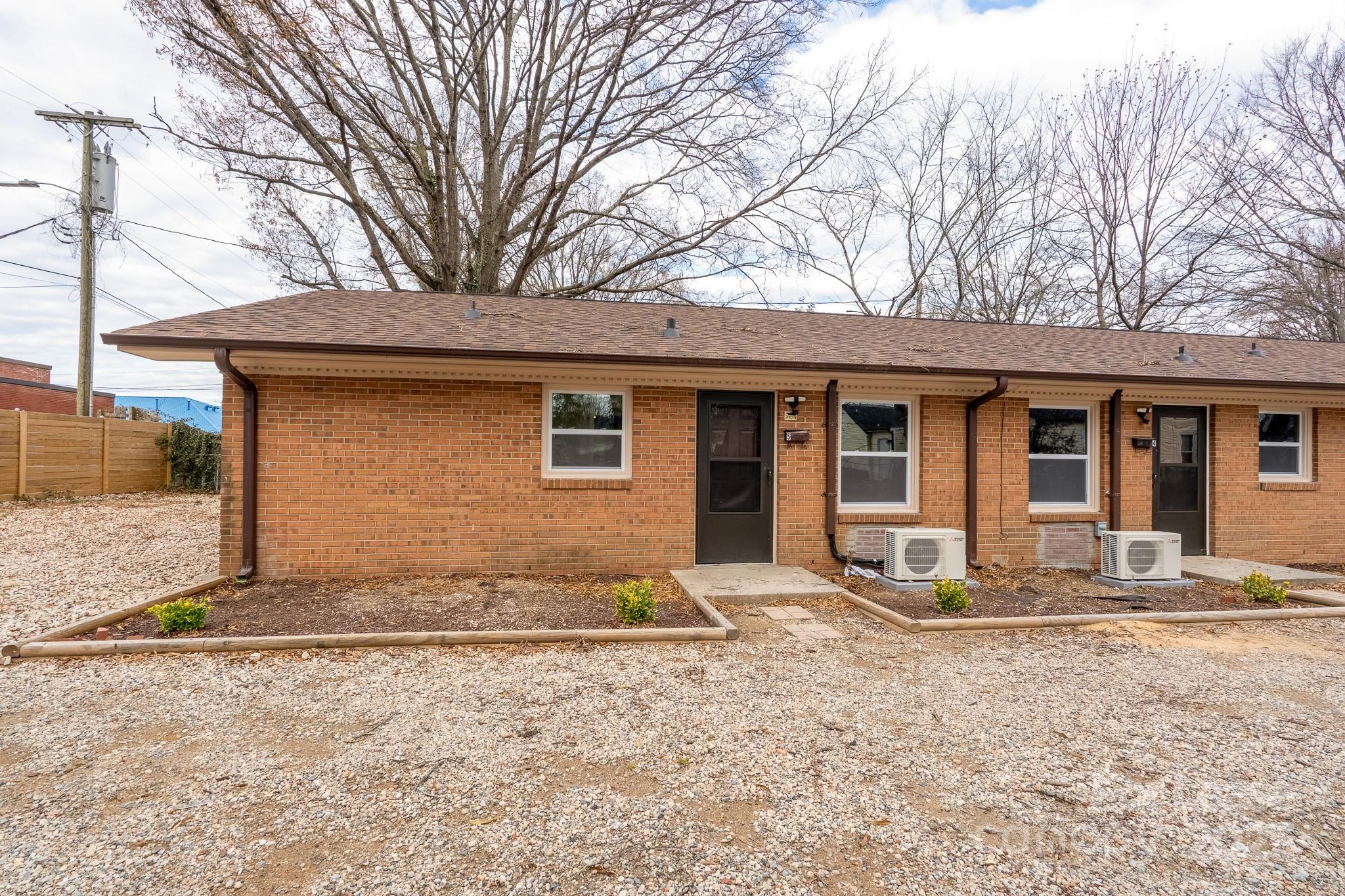 745 Arbor Street Northeast, Unit 5 Concord, NC 28025 - Photo 20 of 20 a front view of a house with a yard and garage