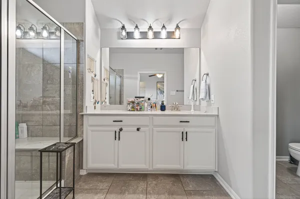 a bathroom with a sink vanity and a mirror