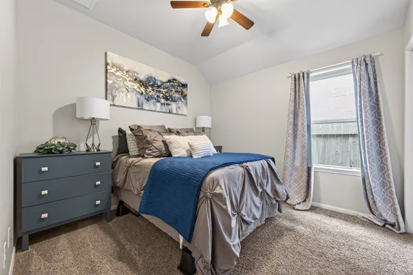 a bedroom with a bed and a window