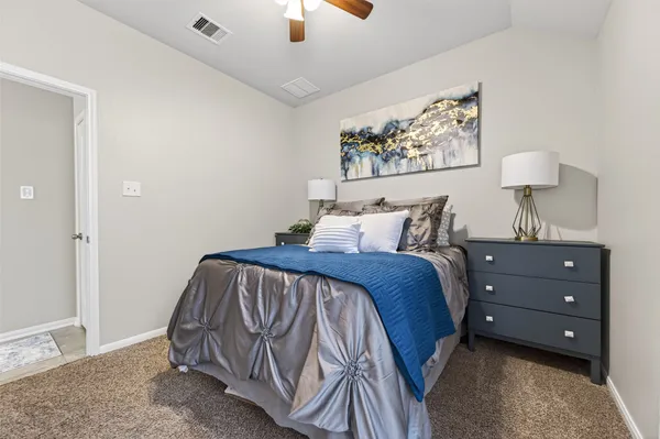 a bedroom with a bed and a painting on the wall