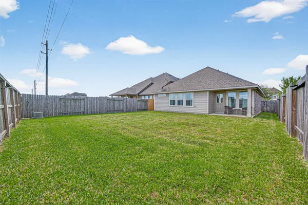 a view of a house with a backyard and a tree