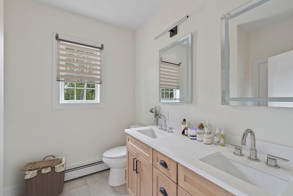 315 South Athol Road Phillipston, MA 01331 - Photo 19 of 42 a bathroom with a toilet a sink a mirror and a window