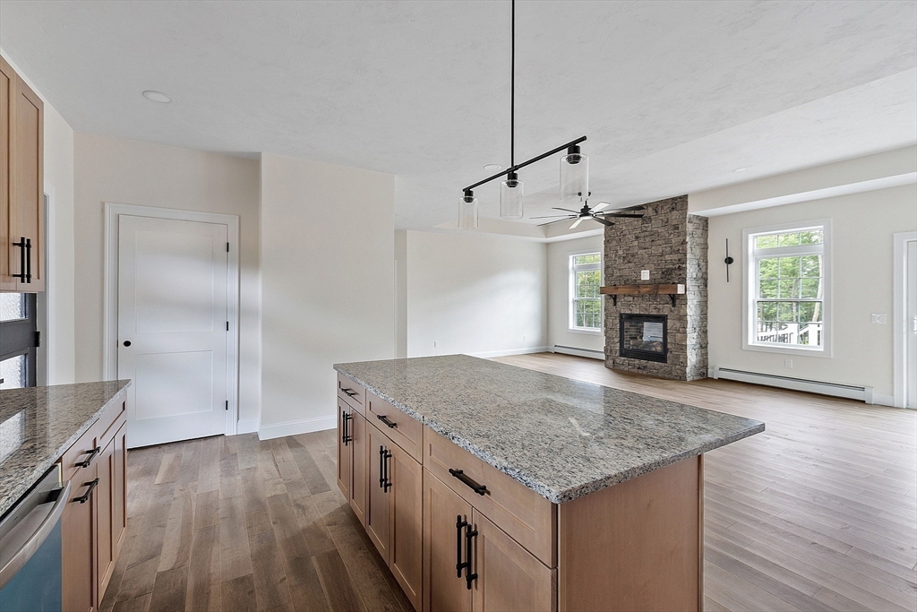 315 South Athol Road Phillipston, MA 01331 - Photo 4 of 42 a kitchen with kitchen island a counter top space wooden floor and a ceiling fan