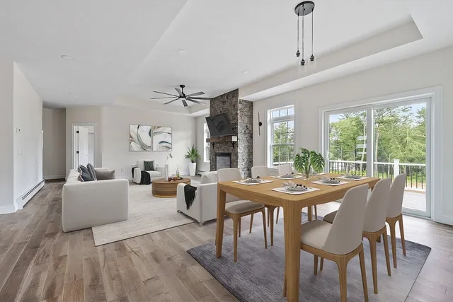 a view of a dining room with furniture wooden floor a livingroom and chandelier