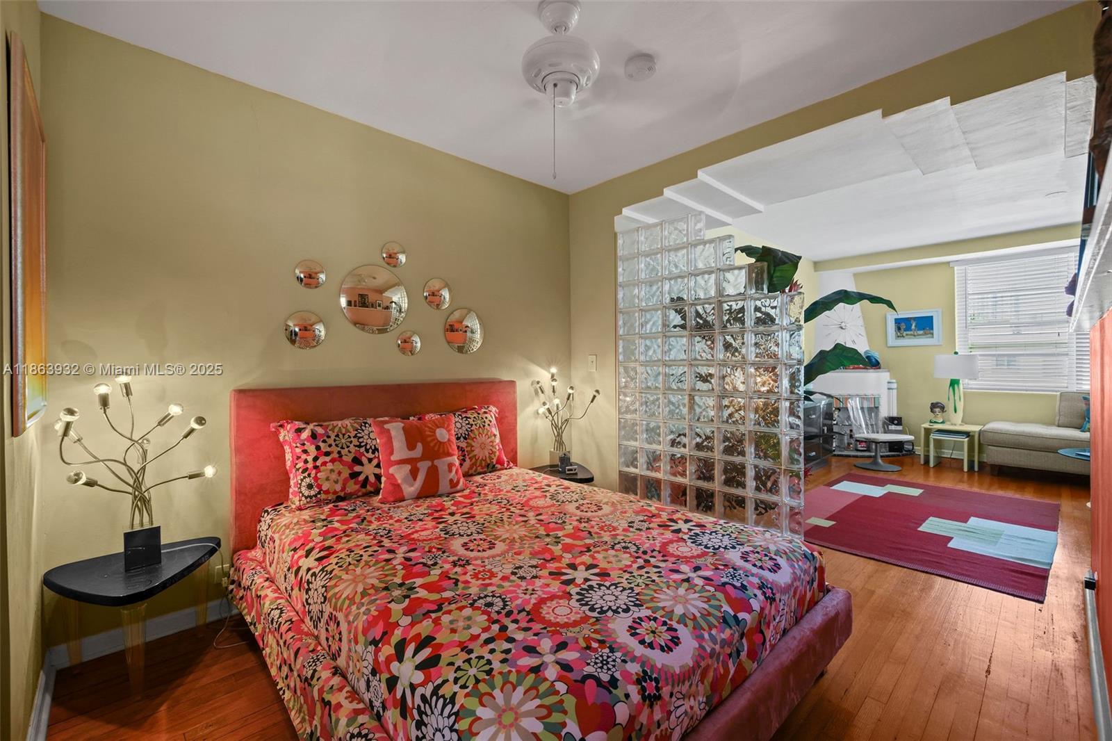 1525 Meridian Avenue, Unit 202 Miami Beach, FL 33139 - Photo 13 of 23 a bedroom with a large bed and a chandelier