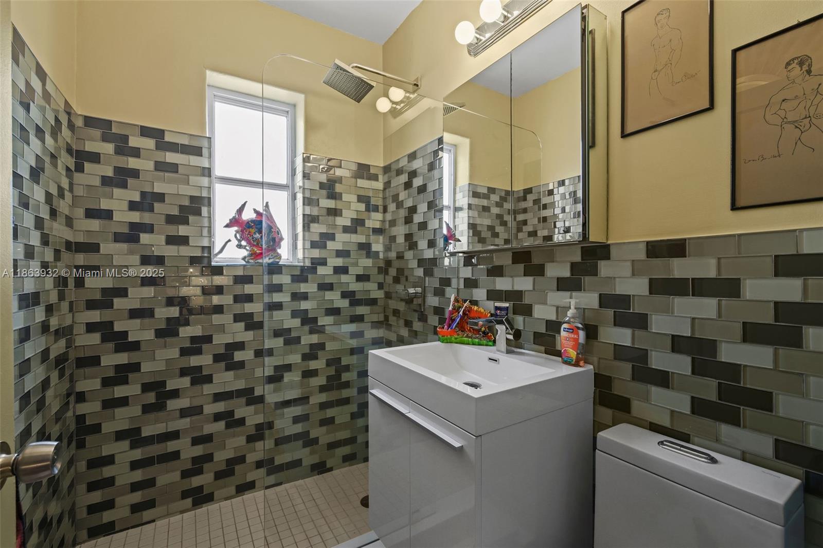 1525 Meridian Avenue, Unit 202 Miami Beach, FL 33139 - Photo 16 of 23 a bathroom with a sink toilet and shower